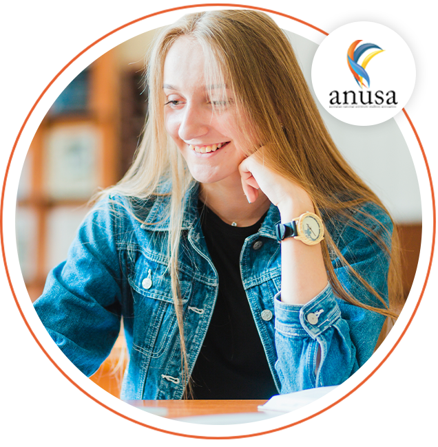 Student smiling at table
