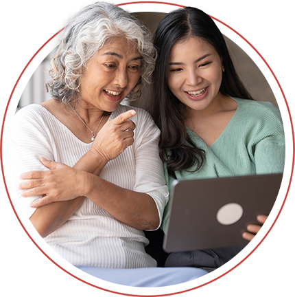 two women looking at a tablet and smiling