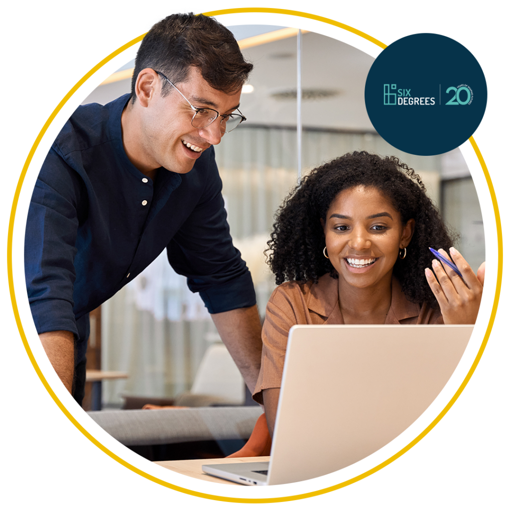 Header image shows 2 people working on a computer and smiling.