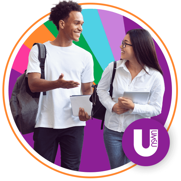Two students smiling and talking to each other