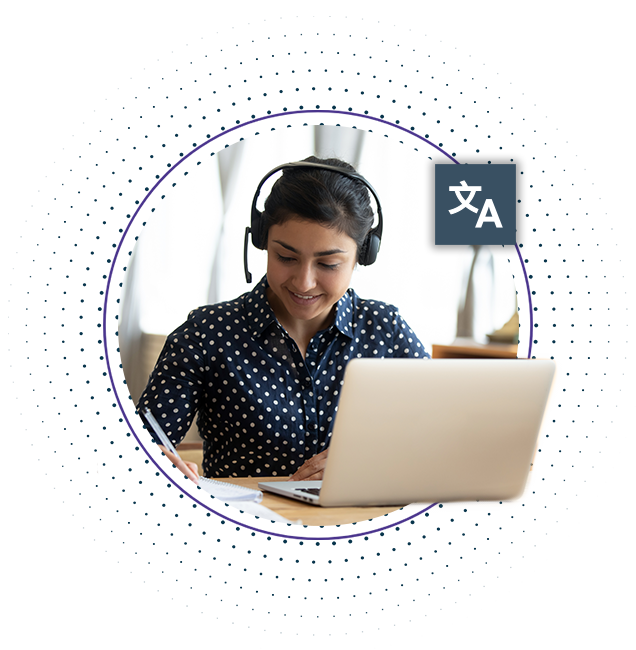 A woman using a laptop while on a phone call using a headset