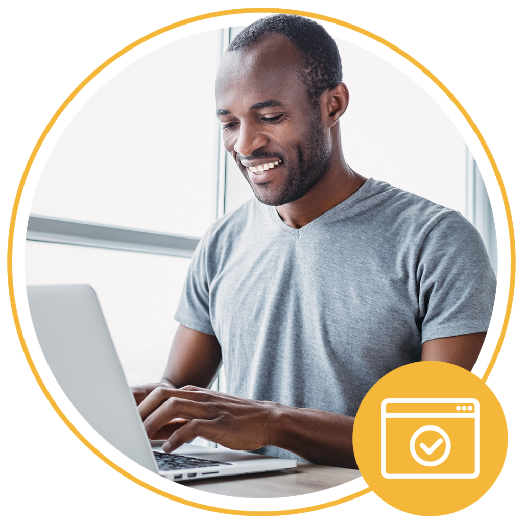 man smiling while using laptop