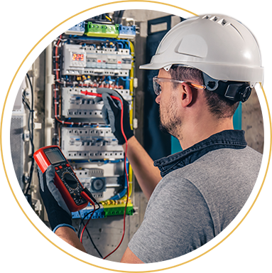 man wearing protective equipment looking at electricals