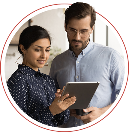 man and woman dressed smartly looking at a tablet