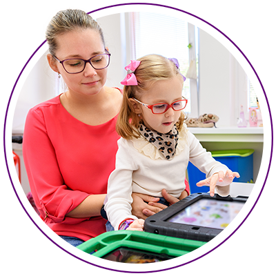 adult and young child playing on a tablet