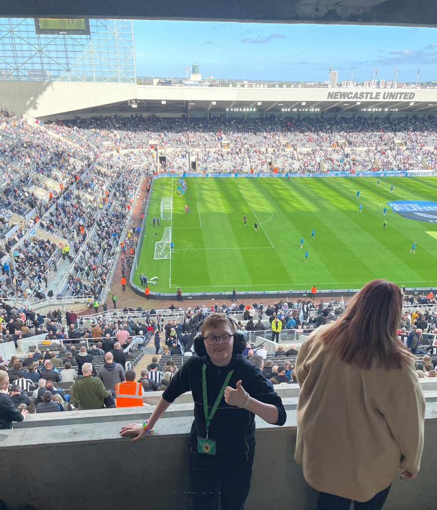 Leighton, one of the competition winners stood by the pitch with his thumbs up