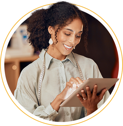woman smiling at an ipad
