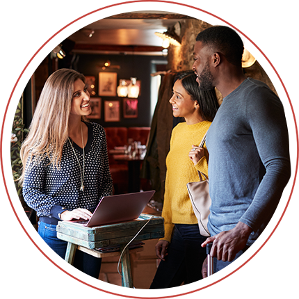 people waiting to be seated at a restaurant, talking to a server