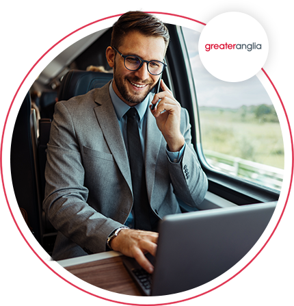 man on a train on his laptop