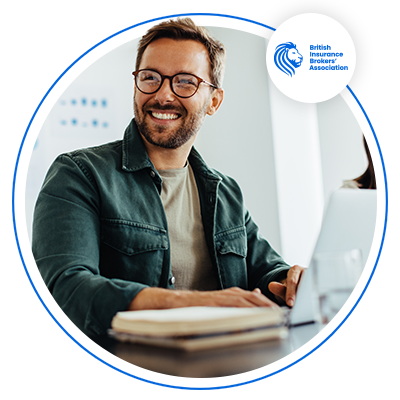 Man using computer sitting at desk smiling