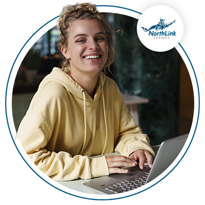 Female using computer and smiling