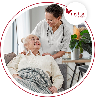 elderly woman lay down being cared for by a nurse