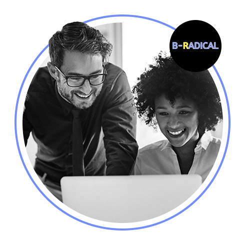 two people looking at a laptop and smiling