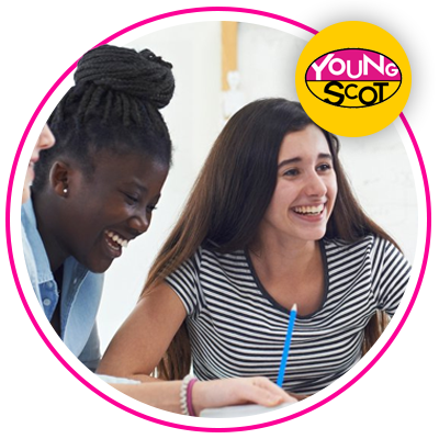 Two students laughing and writing