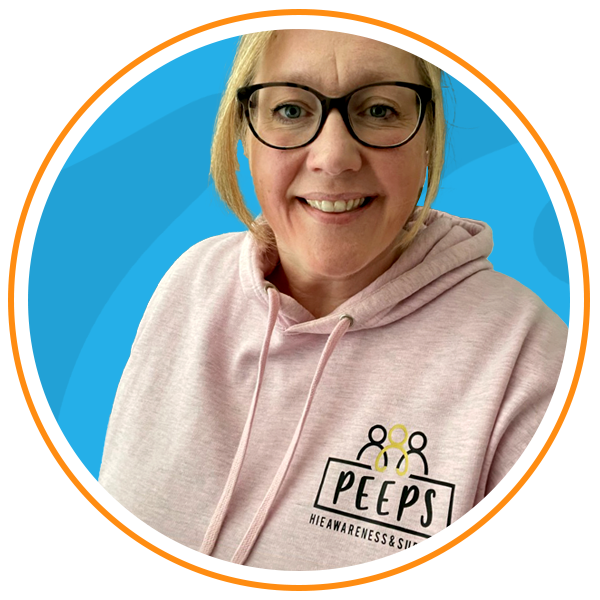 headshot of Sarah smiling into the camera and wearing a Peeps hoody