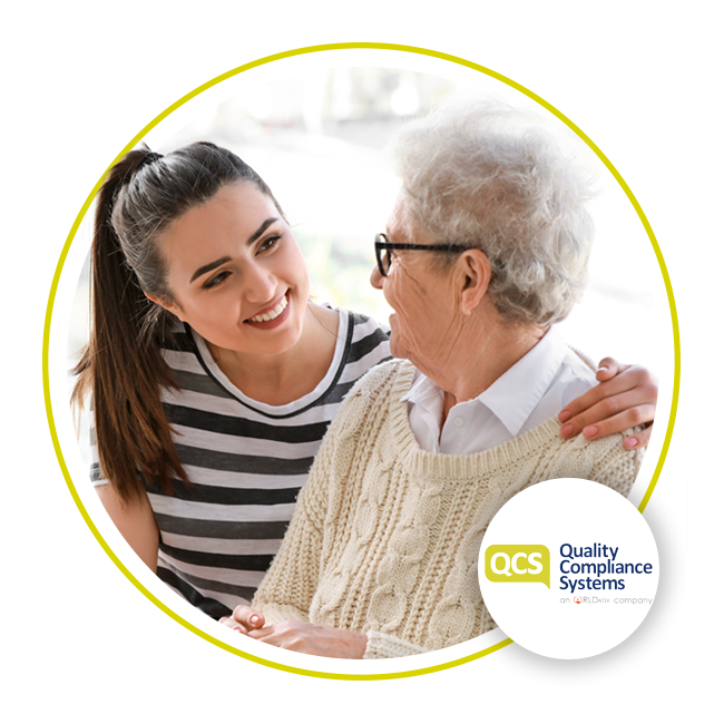 Young lady and elderly lady smiling at each other