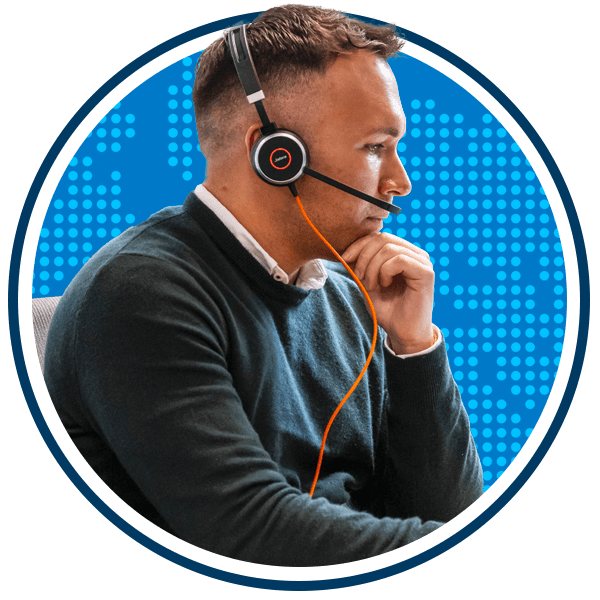 Shaun Hodge using a computer with a headset on