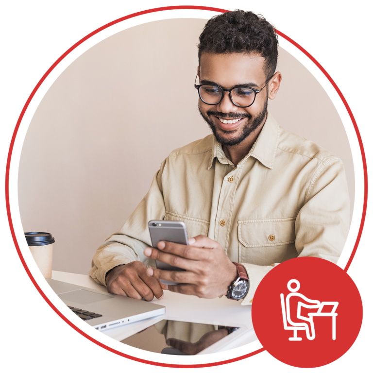 Man smiling and using mobile phone
