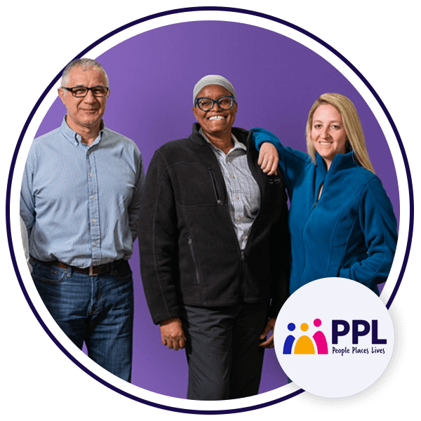 3 people smiling at camera, 1 person is leaning on another.