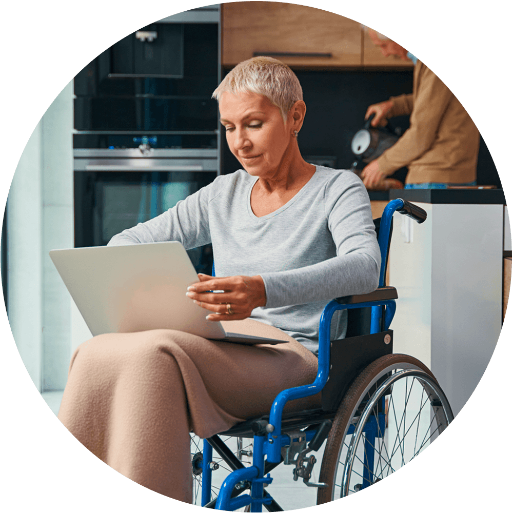 Disabled woman using a laptop at home